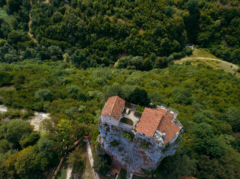 Aerial view. Katskhi pillar. Georgian landmarks. Man's monastery near the village of Katskhi. The orthodox church and the abbot cell on a rocky cliff. Imereti, Georgia. Summer day. Travel and tourism