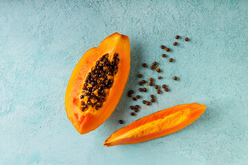 papaya slices lie on a blue background, copy space