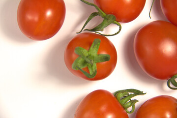 Red tomatoes. On a white background. Top view.