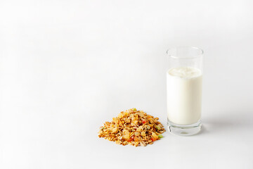 a glass of yogurt and a bunch of muesli on a white background, copy space
