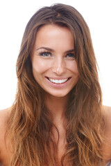 Smiling wide. Beautiful young woman smiling while isolated against a white background.