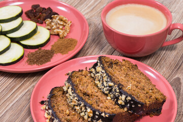Fresh pastry made of zucchini and cup of white coffee. Delicious dessert. Wooden background
