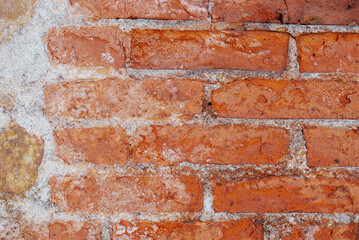 Old brick wall background, brick wall texture, structure. old broken brick, cement joints, close-up.