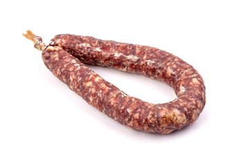 Dry cured pork sausage ring isolated on white
