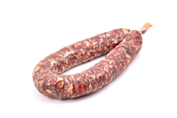 Dry cured pork sausage ring isolated on white