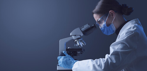 Researcher using a professional microscope