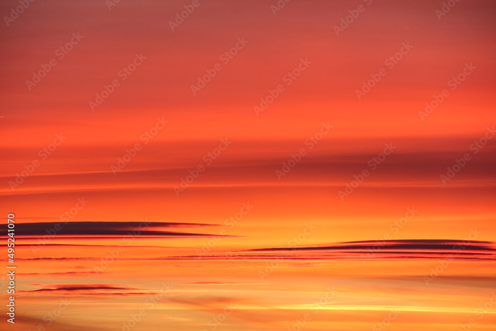 Wall mural Orange sunset and clouds. Color gradients. Close up.