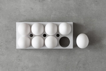 Easter eggs. Chicken white eggs on gray background. A chicken egg as a valuable nutritious product....
