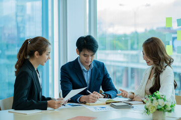 Businessman discussing initial projects A group of young Asian businessmen share ideas and propose new marketing and business ideas at the meeting.