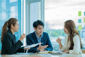 Businessman discussing initial projects A group of young Asian businessmen share ideas and propose...