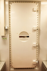 Marine waterproof iron door inside the ship, close-up.
