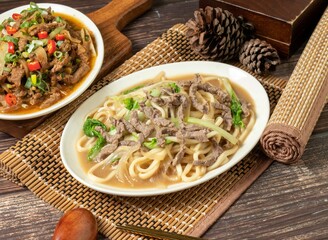 beef chow mein in a dish isolated on mat side view on dark wooden table taiwan food