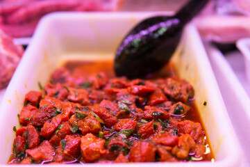 Dressed raw Beef moroccan kebabs on display at a traditional food market.