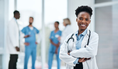 Its my mission to guide you towards better health. Portrait of a young doctor standing in a...