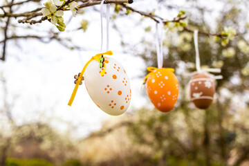 Happy Easter! Easter decorated eggs. Garden tree set up with multicolored Easter eggs.