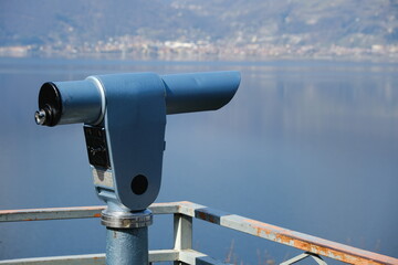 Binoculars, panoramic telescope, point on the lake, concept of looking into the distance