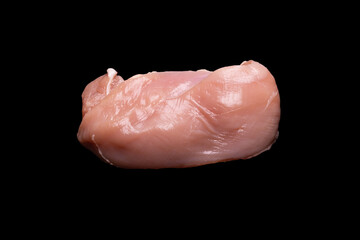 Raw chicken fillet isolated on a black background.