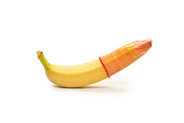 A banana with a condom on it isolated on white background.