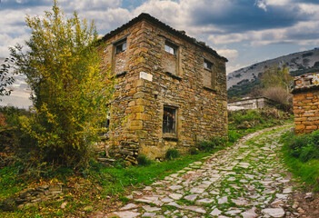 Abandoned, weathered stone house in a mountain town in Gökçeada. Tepeköy village