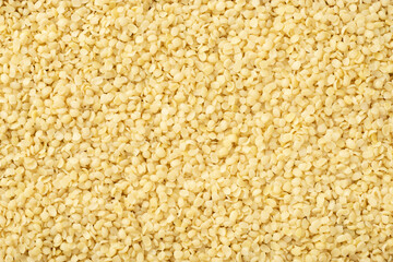 Food background of hulled hemp seeds, top view