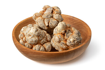 Dried notoginseng roots in the wooden bowl, isolated on the white background.