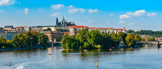 Fototapeta na wymiar Hradcany, view from the Jiraskuv Bridge over the Vltava River on a sunny day.