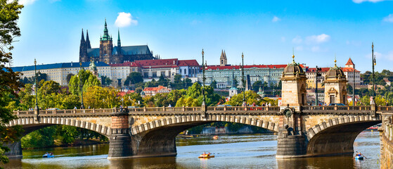 Legion bridge over the Vltava river with Prague Castle in the background, view on a sunny day.