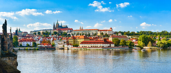 Fototapeta na wymiar Panorama of the city of Prague in Czech Republic on the Vltava River, view from the Charles Bridge over Hradcany on a sunny day.