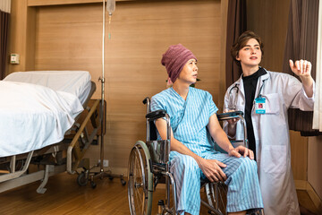 Cancer man patients in wheelchairs receive rehabilitation treatment at clinic. Young female doctor medical therapy treatments.Young patient with a smiling and friendly expression.