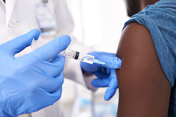 Get one before flu season. Closeup shot of a male patient receiving an injection from a doctor.