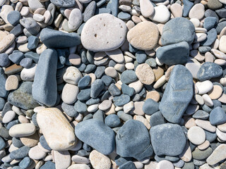 Fototapeta na wymiar Square frame made of stones on beach pebbles in sunlight 