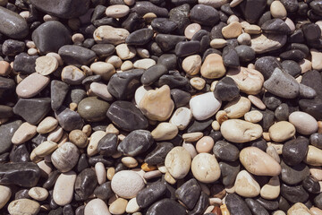 Texture of wet gray and white beach stones and pebbles