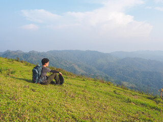 Fototapeta na wymiar Trekking solo backpack on mountain trail in tropical forest at Tak Province, Thailand.
