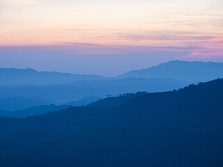 Fototapeta na wymiar Beautiful nature of sunrise and mountains complex with morning mist atmosphere at Tak, Thailand.