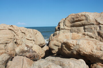 Fototapeta na wymiar Rocks with window of sea in the Background