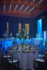 Table setup in blue light. Ready to event. Shallow dof.