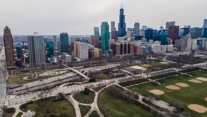 Naklejka na ściany i meble Chicago, IL USA- march 13th 2022: aerial drone shot of downtown Chicago by the river during early spring summer. the beautiful skyscrapers look futuristic along the green lake water