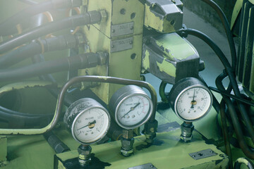 hydraulic pump with motor, solenoid valve, pipe, and pressure gauge.