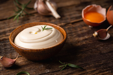 Bowl of Homemade mayonnaise sauce with ingredients and herbs for cooking