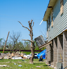 Severely Damaged Air Conditioning Unit on Side of House and Remnants of Tree Stripped by March 22,...