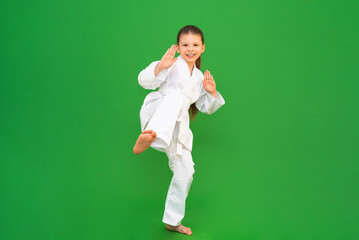Children's self-defense section, a little girl on karate courses, a child in a white kimono on a...