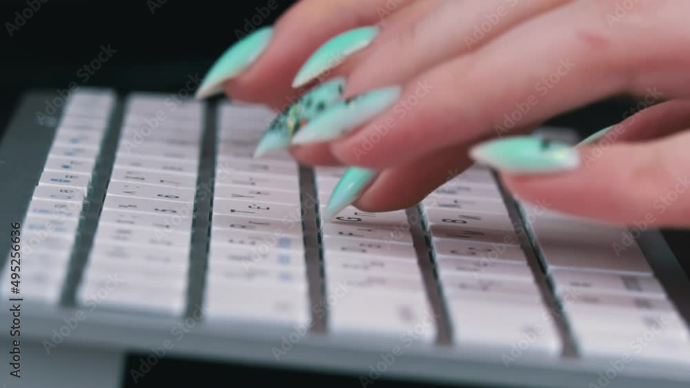 Poster business woman's fingers are typing on the keyboard of a white laptop. the hands of a young girl are