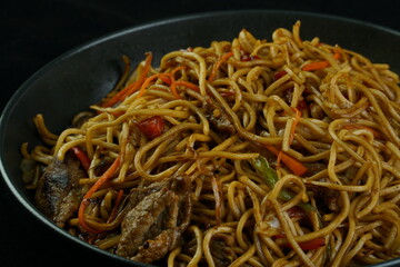 Spaghetti, pasta with tomato sauce and cherry tomatoes with basil on a dark background. Selective focus, copy space. shrimp spaghetti. 
