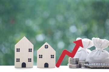 Finance, Model house with red arrow graph and money bag on natural green background,Business investment and Save money for prepare in future concept,Inflation
