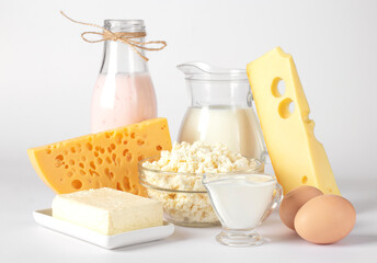Dairy products, Milk, Yogurt, Sour Cream, Assorted Cheese, Cottage Cheese, Butter and Eggs on white background