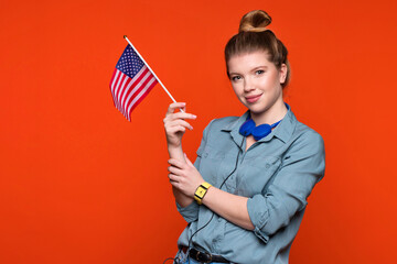 Smiling woman holds small american flag. Female student recommending foreign language studying...