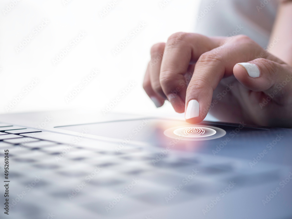 Poster fingerprint scan icon on touchpad on laptop computer while finger scanning for security access with 