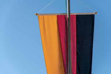 the flag of Germany on the background of a blue sky