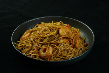 Spaghetti, pasta with tomato sauce and cherry tomatoes with basil on a dark background. Selective focus, copy space. shrimp spaghetti. 