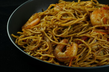 Spaghetti, pasta with tomato sauce and cherry tomatoes with basil on a dark background. Selective focus, copy space. shrimp spaghetti. 